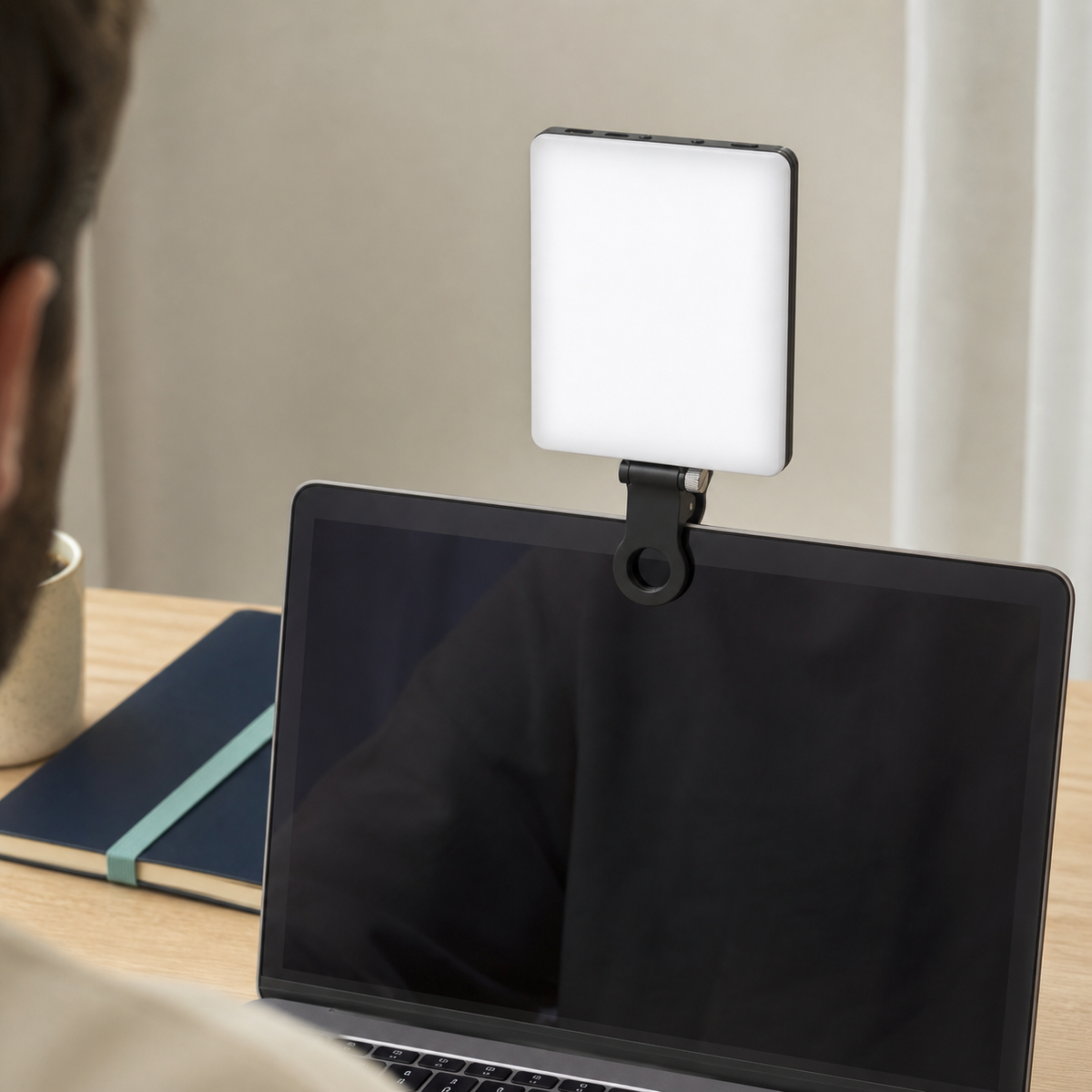 Compact LED filming light clipped above a laptop screen for a creator's video